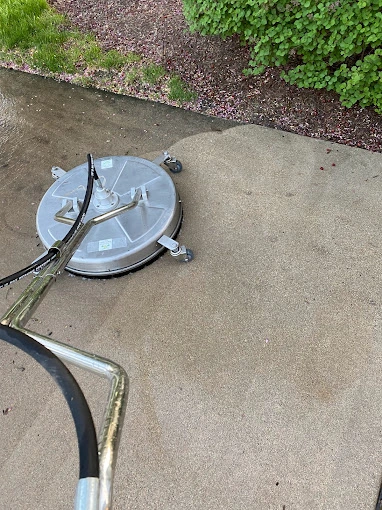 Active power washing process on a residential driveway.