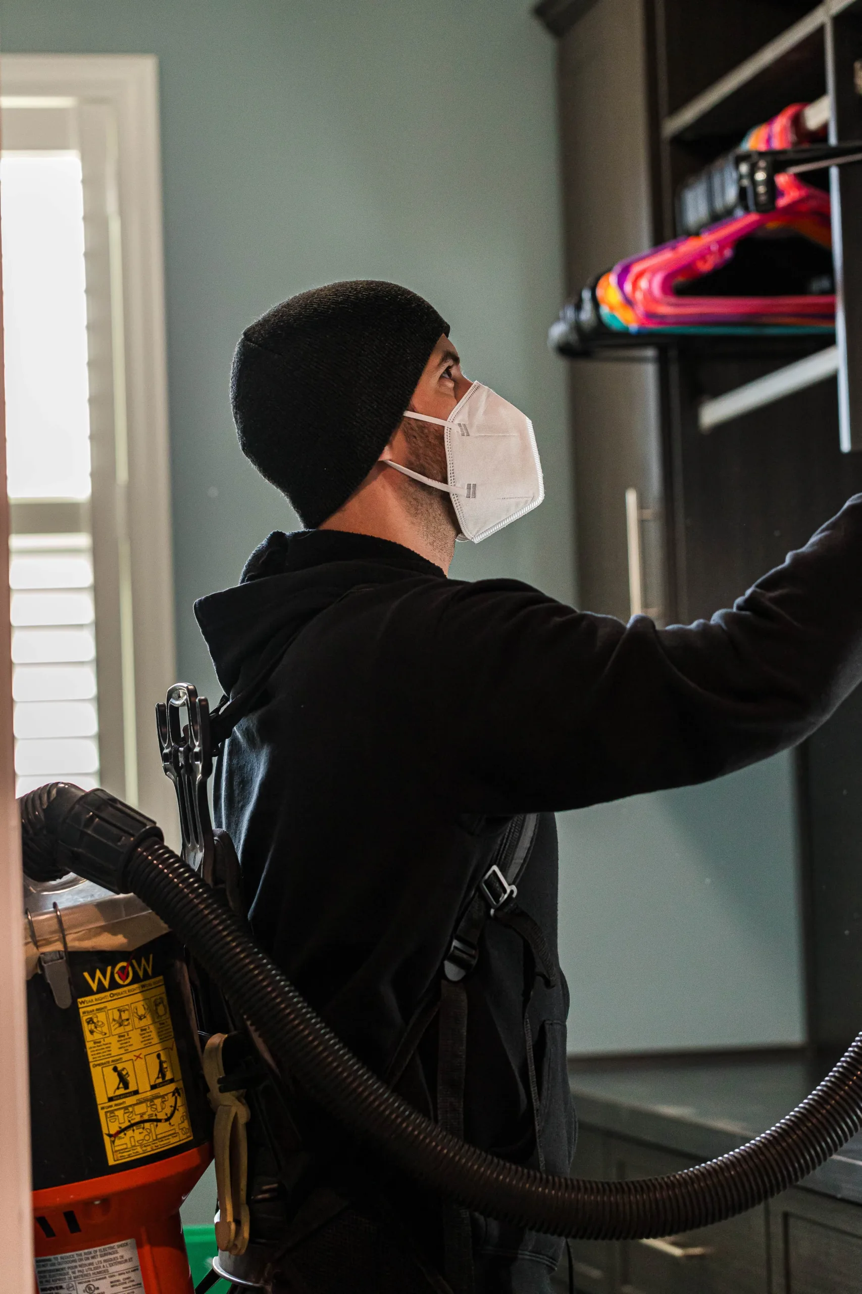 Employee performing residential cleaning in a post-construction environment